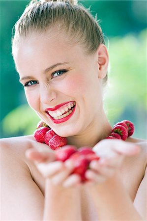 Portrait  of a smiling young woman, necklace of strawberries Stock Photo - Rights-Managed, Code: 877-06832844