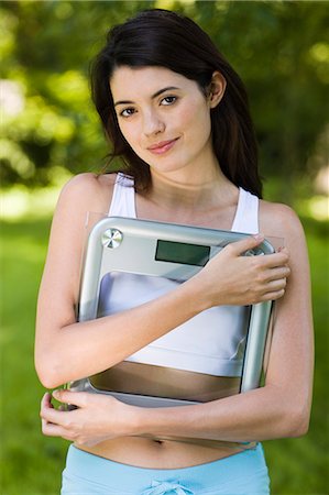 simsearch:877-06832290,k - Young woman holding bathroom scale Stock Photo - Rights-Managed, Code: 877-06833790
