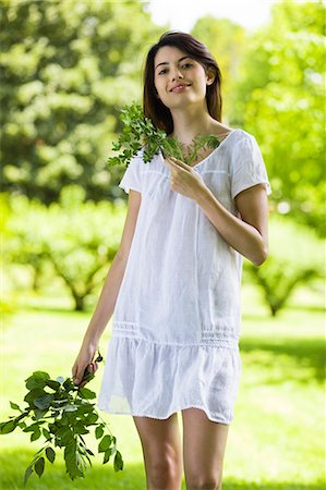 simsearch:877-06832290,k - Young woman holding leaves Stock Photo - Rights-Managed, Code: 877-06833793