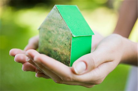 Young woman holding green model house Stock Photo - Rights-Managed, Code: 877-06833800