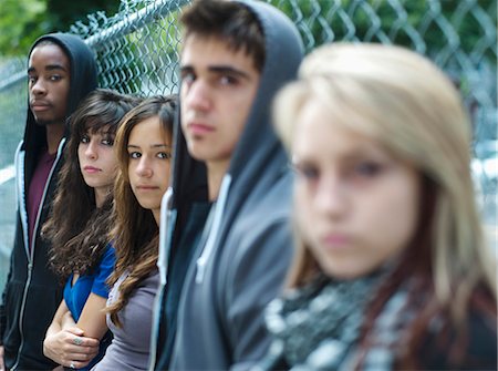 simsearch:877-06833898,k - 5 teenagers leaning against chain link fence Stock Photo - Rights-Managed, Code: 877-06833964