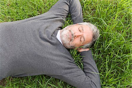 Mature man laying on the grass Stock Photo - Rights-Managed, Code: 877-07460418