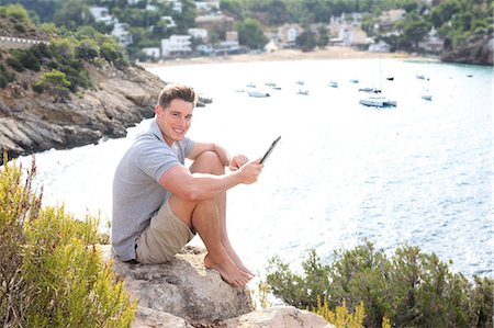 Man sitting with a digital tablet, see in background Stock Photo - Rights-Managed, Code: 877-08026449