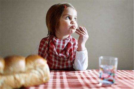 A girl having a snack Stock Photo - Rights-Managed, Code: 877-08031242