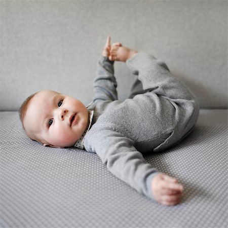 single geometric shape - Baby boy playing with his feet Stock Photo - Rights-Managed, Code: 877-08031324