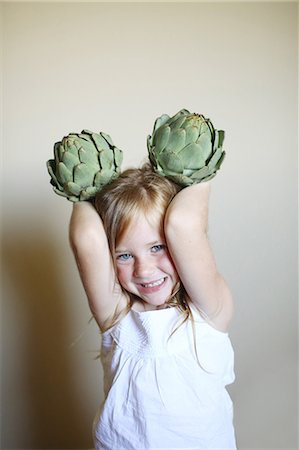 Little girl making ears with artichokes Stock Photo - Rights-Managed, Code: 877-08031321
