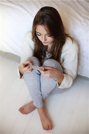 person feet and bed - A teenage girl posing with a plate of contraceptive pills Stock Photo - Rights-Managed, Code: 877-08128051