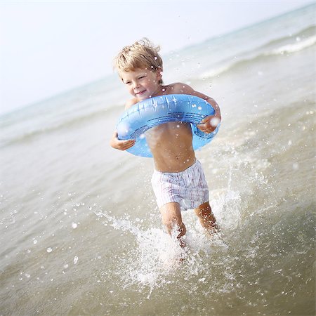 Little boy at the beach with his rubber ring Stock Photo - Rights-Managed, Code: 877-08128124