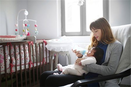 pictures of new born baby rooms - A mom giving a baby bottle of milk to her 2 months old baby. Foto de stock - Con derechos protegidos, Código: 877-08128196