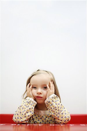 punishment - A 3 years old girl sulking, head in hands, leaning on a school desk Stock Photo - Rights-Managed, Code: 877-08128226