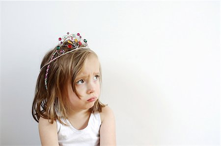 Portrait of a 3 years old girl pouting with a princess crown on the head Stock Photo - Rights-Managed, Code: 877-08128233