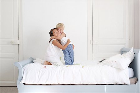 photo boys jumping bed - Brother and sister plying on a bed Stock Photo - Rights-Managed, Code: 877-08128923