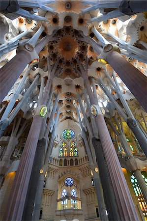 Sagrada Familia. Basilica and Expiatory Church of the Holy Family in Barcelona. Antoni Gaudi. Interior. Column, ceiling and stained glass window. Spain. Stock Photo - Rights-Managed, Code: 877-08129540