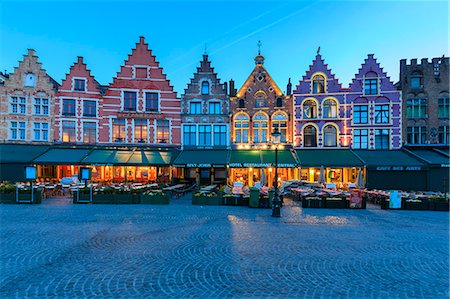 Blue lights of dusk on the colorful medieval houses in Market Square Bruges West Flanders Belgium Europe Stock Photo - Rights-Managed, Code: 879-09021232