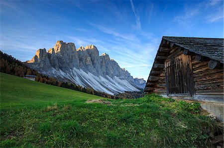 The early morning light illuminates Malga Zannes and the Odle in background. Funes Valley South Tyrol Dolomites Italy Europe Stock Photo - Rights-Managed, Code: 879-09034109