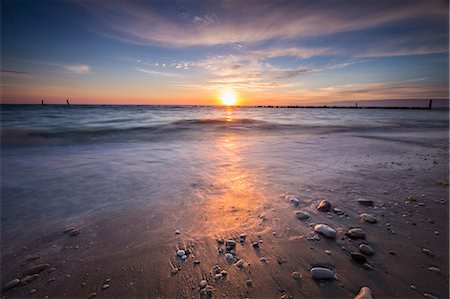 stone in water - The lights of dawn are reflected on the sandy beach Porto Recanati Province of Macerata Conero Riviera Marche Italy Europe Stock Photo - Rights-Managed, Code: 879-09034260