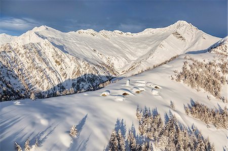 Italy, Italian Alps, Lombardy, The huts and the bell tower of Alpe Cima sorrounded by metres of snow Stock Photo - Rights-Managed, Code: 879-09033220