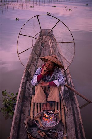 simsearch:400-05676936,k - Inle lake, Nyaungshwe township, Taunggyi district, Myanmar (Burma). Local fisherman before dawn with fireplace on the boat. Stock Photo - Rights-Managed, Code: 879-09033496