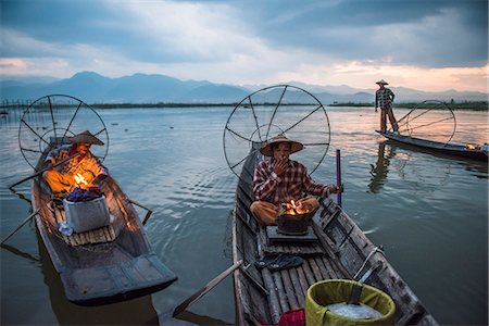 simsearch:400-05676936,k - Inle lake, Nyaungshwe township, Taunggyi district, Myanmar (Burma). Local fisherman before dawn with fireplace on the boat. Stock Photo - Rights-Managed, Code: 879-09033497