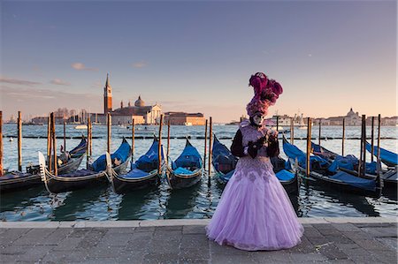 Venice, Veneto, Italy. A traditional mask at Venice Carnival with St George island and some gondolas in background at sunset. Stock Photo - Rights-Managed, Code: 879-09043604