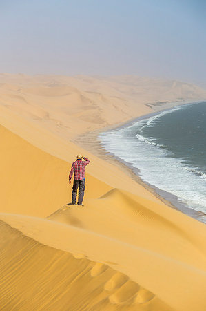 simsearch:862-03365353,k - Between desert and ocean a man admires the view,Sandwich Harbour,Namib Naukluft National Park,Namibia,Africa Stock Photo - Rights-Managed, Code: 879-09189763