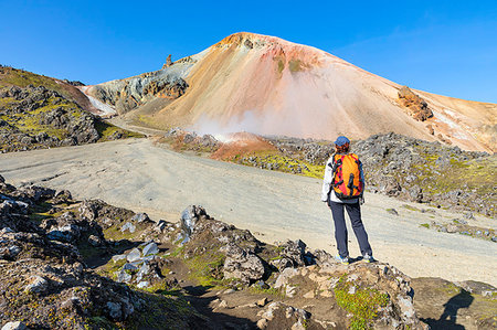 Graenagil footpath: a trekker is looking the Brennisteinsalda mountain from the Laugahraun lava field in Landmannalaugar (Fjallabak Nature Reserve, Highlands, Southern Region, Iceland, Europe) (MR) Stock Photo - Rights-Managed, Code: 879-09190363