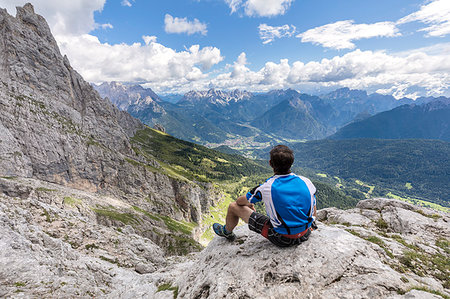 Europe, Italy, Veneto, Agordino, Mountaineer observes the panorama at the end of the ferrata Stella Alpina on Mount Agner, Pale di San Martino, Dolomites Stock Photo - Rights-Managed, Code: 879-09190578