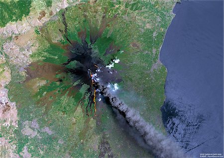 satellite image - Mount Etna, Sicily, True Colour Satellite Image. Satellite image of Mount Etna, the highest active volcano in Europe, situated North-East of Sicily, 3350m high. Image taken on 23 July 2001 using LANDSAT data. Stock Photo - Rights-Managed, Code: 872-06052997