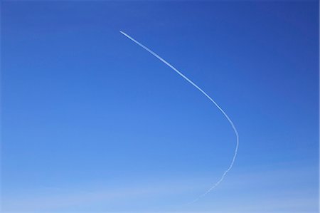 environmental impact - Contrail of airplane outlined in clear blue sky over Suffolk, England, UK. Stock Photo - Rights-Managed, Code: 872-08637910