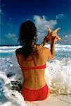 Back View of Woman in Swimwear on Beach, Holding Starfish Cancun, Mexico