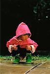 Little Girl Kneeling Outdoors