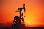 Silhouette of Oil Pump Jack at Sunset Long Beach, California, USA