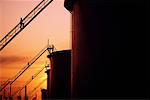 Workers on Staircases of Oil Storage Tanks at Sunset Near Edmonton, Alberta, Canada