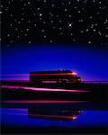 Silhouette of Transport Truck at Night with Light Trails and Starry Sky