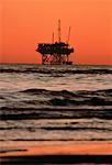 Silhouette of Offshore Oil Rig at Sunset