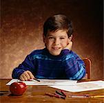 Portrait of Boy Sitting at Desk