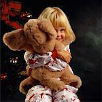 Portrait of Girl Hugging Stuffed Animal At Christmas