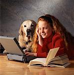 Girl with Dog Using Laptop Computer