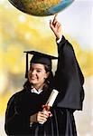 Female Graduate with Diploma Balancing Globe