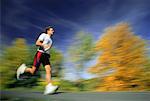 Blurred View of Man Running Outdoors in Autumn