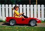 Girl Riding in Toy Car
