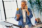 Man Using Cordless Phone at Drafting Table