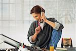 Woman Using Phone in Home Office