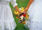 Close-Up of Girls Holding Bouquet Of Flowers