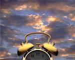 Alarm Clock Ringing with Cloudy Sky Background