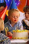 Little Boy Blowing Out Birthday Cake Candles