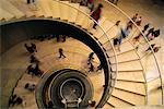 Looking Down at People Walking On Spiral Staircase