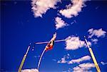 Looking Up at Man Pole Vaulting