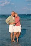 Mature Couple Standing in Surf On Beach Key Biscayne, Florida, USA