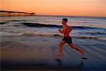 Man Running on Beach at Sunset